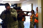 Airmen from the 802nd Security Forces Squadron perform a security sweep while attempting to locate active shooters during the Active Shooter training exercise Feb. 12, 2016 at the Joint Base San Antonio-Lackland Reid Clinic. Members of the 59th MDW and 802nd Security Forces Squadron are training to deal with threats of violence at military medical facilities. (U.S. Air Force photo/Staff Sgt. Jason Huddleston)