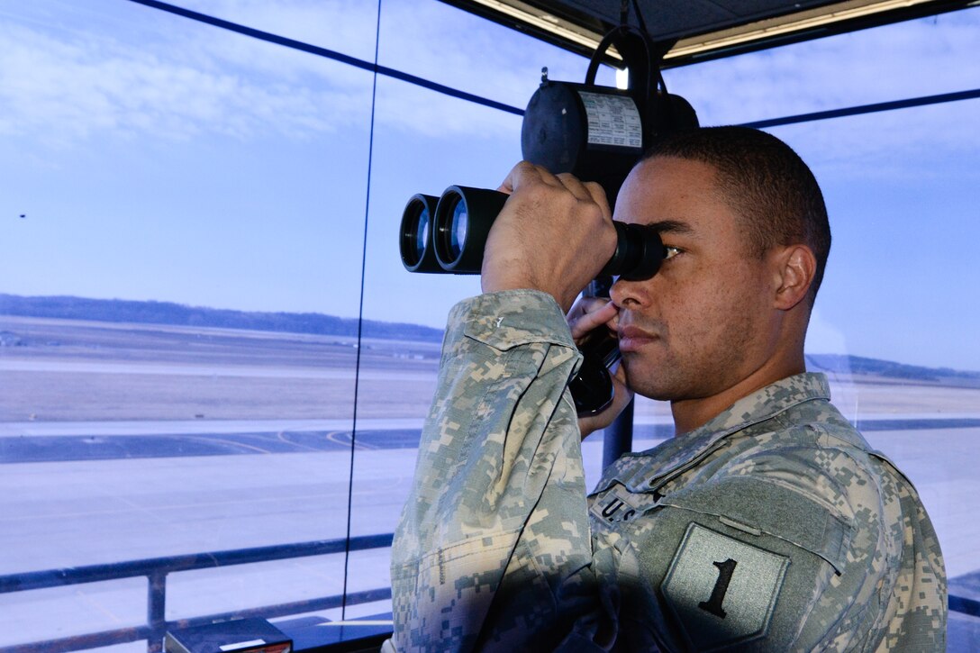 U.S. Army Spc. Bryan Tapscott from Ft. Riley, Kan., looks through binoculars at Rosecrans Air National Guard Base, St. Joseph, Mo., on Feb. 26, 2016. Tapscott and another soldier are the first soldiers to be trained by the 241st Air Traffic Control Squadron to become air traffic controllers. The training is eight months long and will be in rotation of other soldiers. (U.S. Air National Guard photo by Senior Airman Bruce Jenkins/Released)