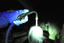 Staff Sgt. John Stevens, 8th Maintenance Squadron non-destructive inspection shift supervisor, uses ultraviolet lights to inspect aircraft parts March 2, 2016, at Kunsan Air Base, Republic of Korea. The 8th MXS NDI shop inspects metal objects ranging from nuts and bolts, to large hooks and sheets of metal to ensure the safety of the aicraft. (U.S. Air Force photo/Senior Airman Dustin King)