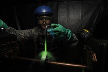 Staff Sgt. John Stevens, 8th Maintenance Squadron non-destructive inspection shift supervisor, uses ultraviolet lights to inspect aircraft parts March 2, 2016, at Kunsan Air Base, Republic of Korea. The 8th MXS NDI shop inspects metal objects ranging from nuts and bolts, to large hooks and sheets of metal to ensure the safety of the aicraft. (U.S. Air Force photo/Senior Airman Dustin King)