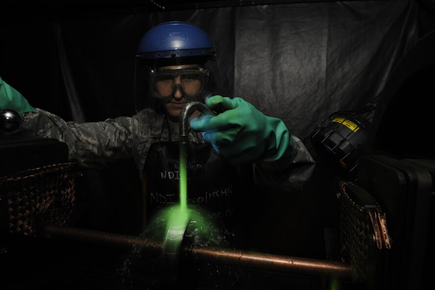 Staff Sgt. John Stevens, 8th Maintenance Squadron non-destructive inspection shift supervisor, uses ultraviolet lights to inspect aircraft parts March 2, 2016, at Kunsan Air Base, Republic of Korea. The 8th MXS NDI shop inspects metal objects ranging from nuts and bolts, to large hooks and sheets of metal to ensure the safety of the aicraft. (U.S. Air Force photo/Senior Airman Dustin King)