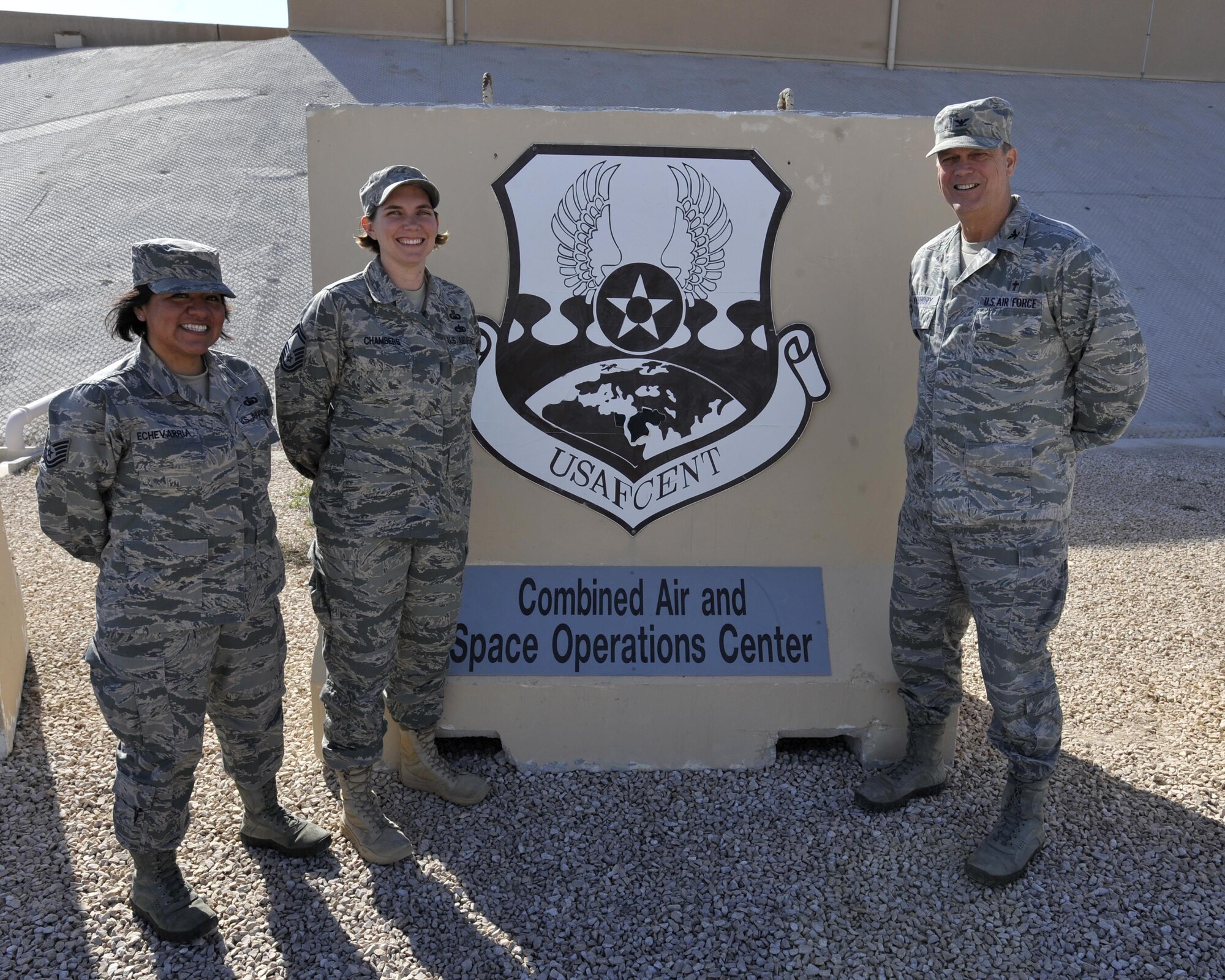 Chaplain (Col.) Greg Woodbury, command chaplain, poses with the other members of the U.S. Air Forces Central Command (AFCENT) Religious Support Team (RST), 
Senior Master Sgt. Sadie Chambers, middle, and Tech. Sgt. Shana Echevarria, left, at Al Udeid Air Base, Qatar. The RST ensures that every AFCENT Service member is able to exercise their religious preference. (U.S. Air Force photo by Master Sgt. Joshua Strang)
