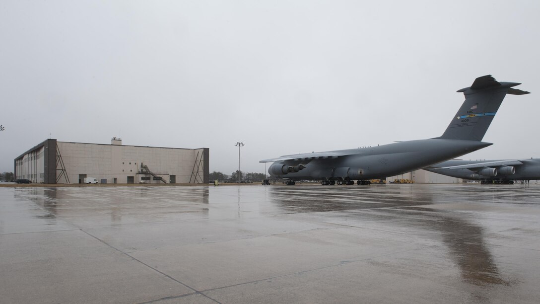 A C-5M Super Galaxy, operated by the 436th Airlift Wing, sits on the flight line outside of Big Beige Feb. 24, 2016, at Joint Base McGuire-Dix-Lakehurst, N.J. Big Beige, named for its size and color, is the temporary home of the 436th Maintenance Group and has been affectionately dubbed “Dover North” by the maintainers. (U.S. Air Force photo/Senior Airman Zachary Cacicia)