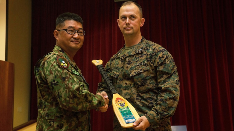 U.S. Marine Corps Lt. Col. Matthew Lundgren, commanding officer, 1st Battalion, 4th Marine Regiment, 1st Marine Division, receives a plaque from Col. Yoskiyuki Goto, regimental commander, Western Army Infantry Regiment, Japan Ground Self-Defense Force, at Marine Corps Base Camp Pendleton, California, March 1, 2016, during the closing ceremony of Exercise Iron Fist 2016. Exercise Iron Fist is an annual, bilateral amphibious training exercise conducted by the USMC and JGSDF is designed to improve their ability to conduct combined amphibious operations. The ceremony concluded the 11th iteration of the exercise, which will continue to provide unique opportunities for the U.S. Marines to train with their Pacific ally on U.S. soil.