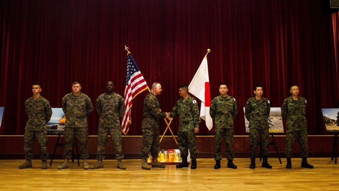 U.S. Marine Corps Col. Clay Tipton, commanding officer, 11th Marine Expeditionary Unit, shakes hands with Col. Yoskiyuki Goto, commanding officer, Western Army Infantry Regiment, Japan Ground Self-Defense Force, after recognizing select Marines and JGSDF soldiers for their outstanding  performance during Exercise Iron Fist 2016, at the exercise’s closing ceremony at Marine Corps Base Camp Pendleton, California, March 1, 2016. Exercise Iron Fist is an annual exercise conducted between the USMC and JGSDF, designed to improve their ability to conduct amphibious operations. The ceremony brought together both militaries in celebration and formally concluded the 11th iteration of Exercise Iron Fist.