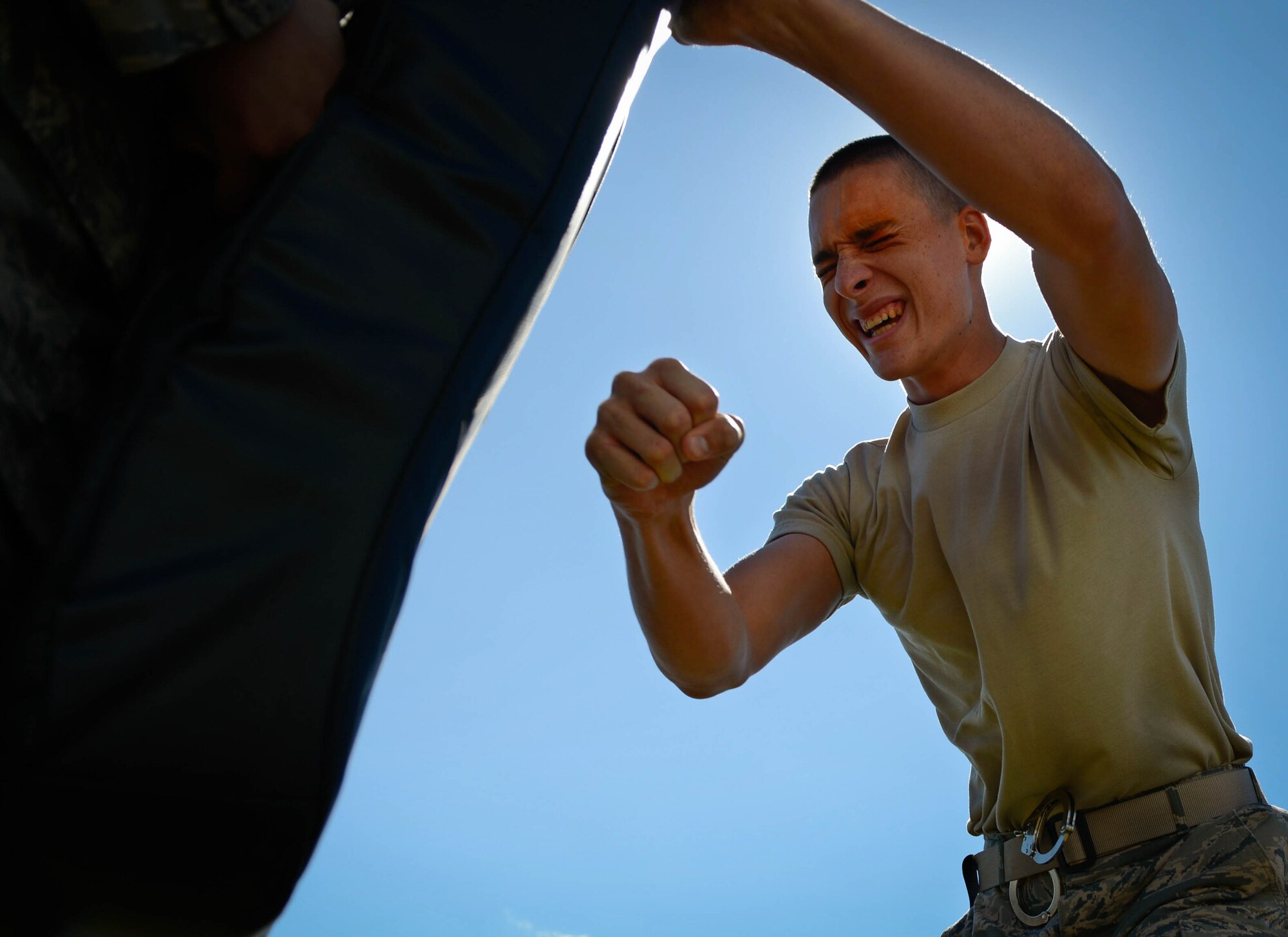 U.S. Air Force Airman Zachary Russel, 20th Security Forces Squadron journeyman, punches a simulated perpetrator after exposure to pepper spray during training at Shaw Air Force Base, S.C., Feb. 29, 2016. The training prepares 20th SFS Airmen on the actions to take if pepper sprayed. (U.S. Air Force photo by Senior Airman Jensen Stidham)