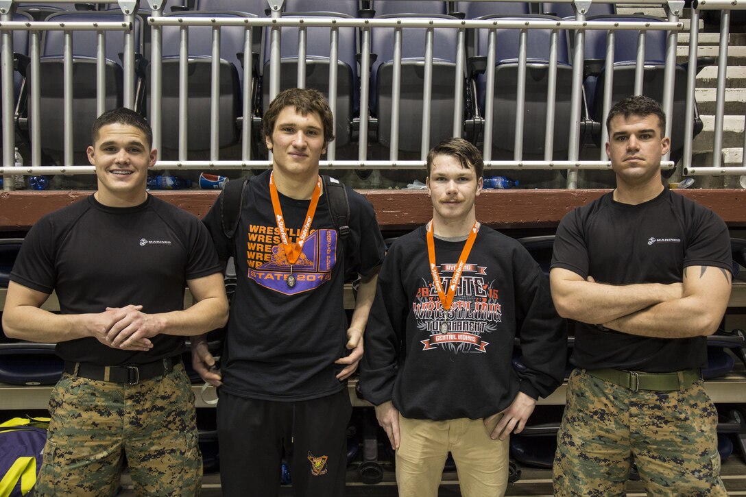 From left to right, Sgt. Justin Bueno, a recruiter with Recruiting Station Denver, River Schroeder, a Burns High School student, Ryder Jones, a Cheyenne Central High School student, and Staff Sgt. Jeffrey Dugan, a recruiter with RS Denver, pose together after the Wyoming State High School Wrestling Tournament, at the Casper Event Center in Casper, WY, Feb. 26 – 27, 2016. Schroeder placed second overall in his weight class of 195 lbs., and Jones placed second overall in his weight class of 126 lbs. The high school students, who are standing next to their respective recruiters, leave for recruit training in August this year. 