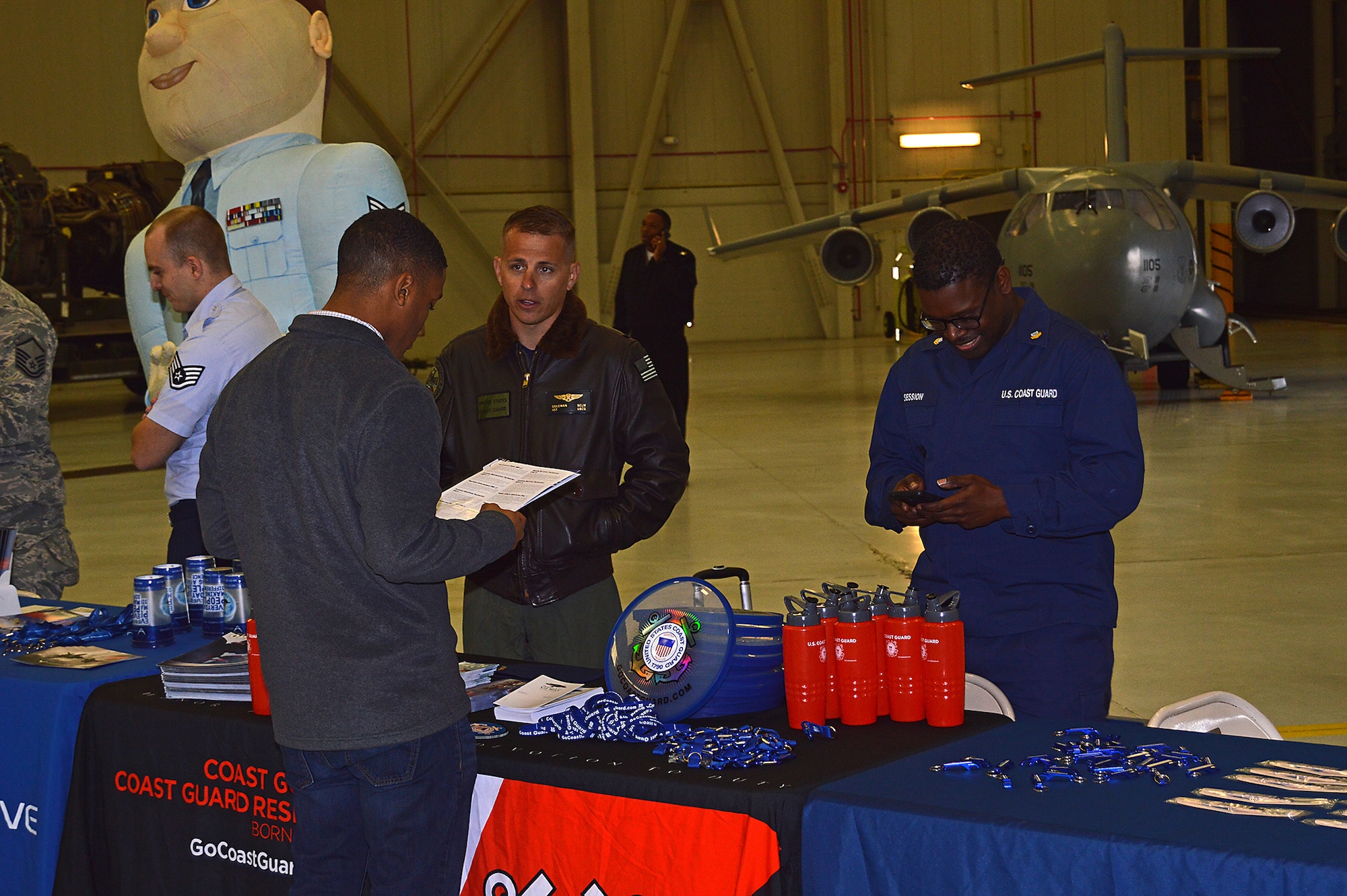 Aviation Survival Technician Colman Selm, a Coast Guard rescue swimmer in Charleston, tells a student about career options in the Coast Guard during the Joint Base Charleston Tuskegee Airmen Career Day Feb. 25, 2016. The 315th Airlift Wing's first Tuskegee Airmen Career Day drew  over 130 local teenage boys to Joint Base Charleston, S.C. to learn about careers in aviation. The event also celebrated the story of the first black pilots in the American military – the Tuskegee Airmen. (courtesy photo by Senior Master Sgt. Eric Keys)