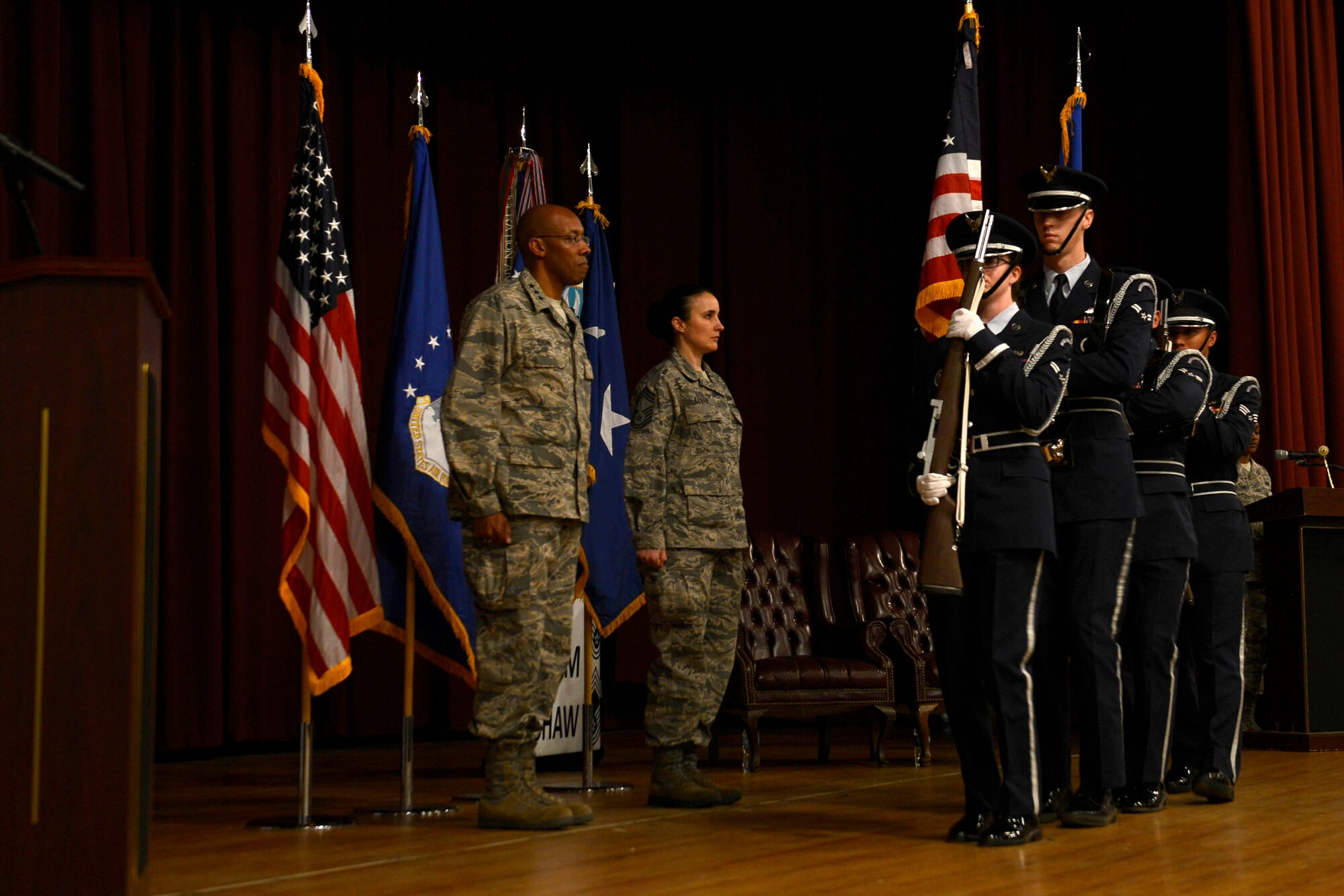 U.S. Air Force Lt. Gen. Charles Q. Brown Jr., commander, U.S. Air Forces Central Command, and Chief Master Sgt. Summer Leifer, AFCENT chief enlisted manager, stand at attention as the 20th Force Support Squadron honor guard presents the colors during a promotion ceremony at Shaw Air Force Base, S.C., Feb. 29, 2016. The promotion ceremony began with the presentation of the colors, followed by the awarding of a Bronze Star medal. (U.S. Air Force photo by Airman 1st Class Christopher Maldonado)