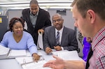 DLA Energy Bulk Petroleum Deputy Director Gerald Tinner (center) and his team discuss a current fuel project. Tinner and his team played a role in writing contracts for the Haiti Earthquake relief efforts.