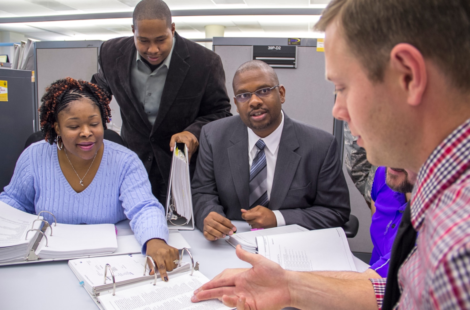 DLA Energy Bulk Petroleum Deputy Director Gerald Tinner (center) and his team discuss a current fuel project. Tinner and his team played a role in writing contracts for the Haiti Earthquake relief efforts.