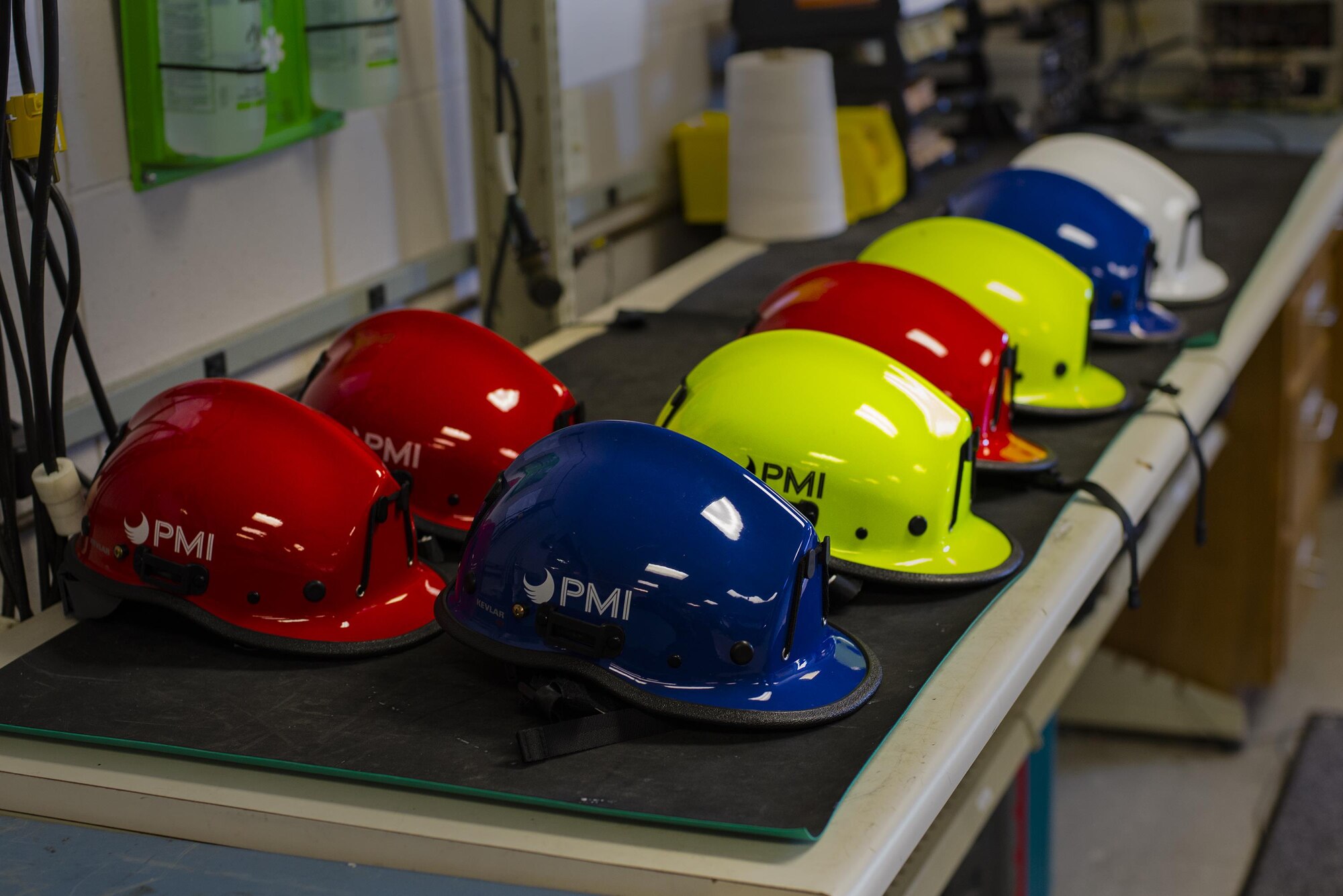 Hard helmets rest on a workbench at the 23d Operations Support Squadron, Feb. 26, 2016, at Moody Air Force Base, Ga. Airmen are able to safely climb and repel from antenna towers using specialized repelling equipment. (U.S. Air Force photo by Airman Daniel Snider/Released)