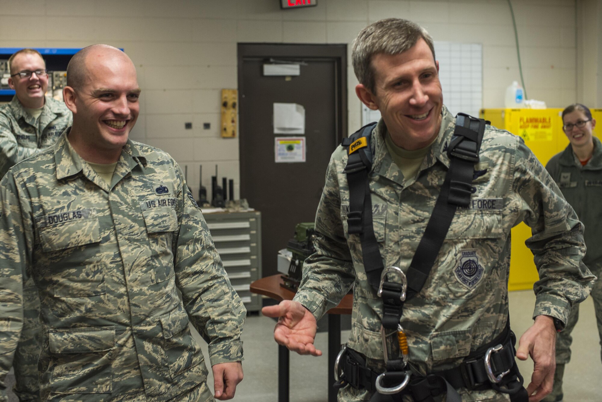 U.S. Air Force Col. Thomas Kunkel, 23d Wing commander, right, shares a laugh with Staff Sgt. Bradley Douglas, 23d Operations Support Squadron airfield systems supervisor, during a visit to the ground air transmit receiver site Feb. 26, 2016, at Moody Air Force Base, Ga. Prior to climbing the antenna towers, Airmen must inspect all equipment for any defects to ensure safety. (U.S. Air Force photo by Airman Daniel Snider/Released)