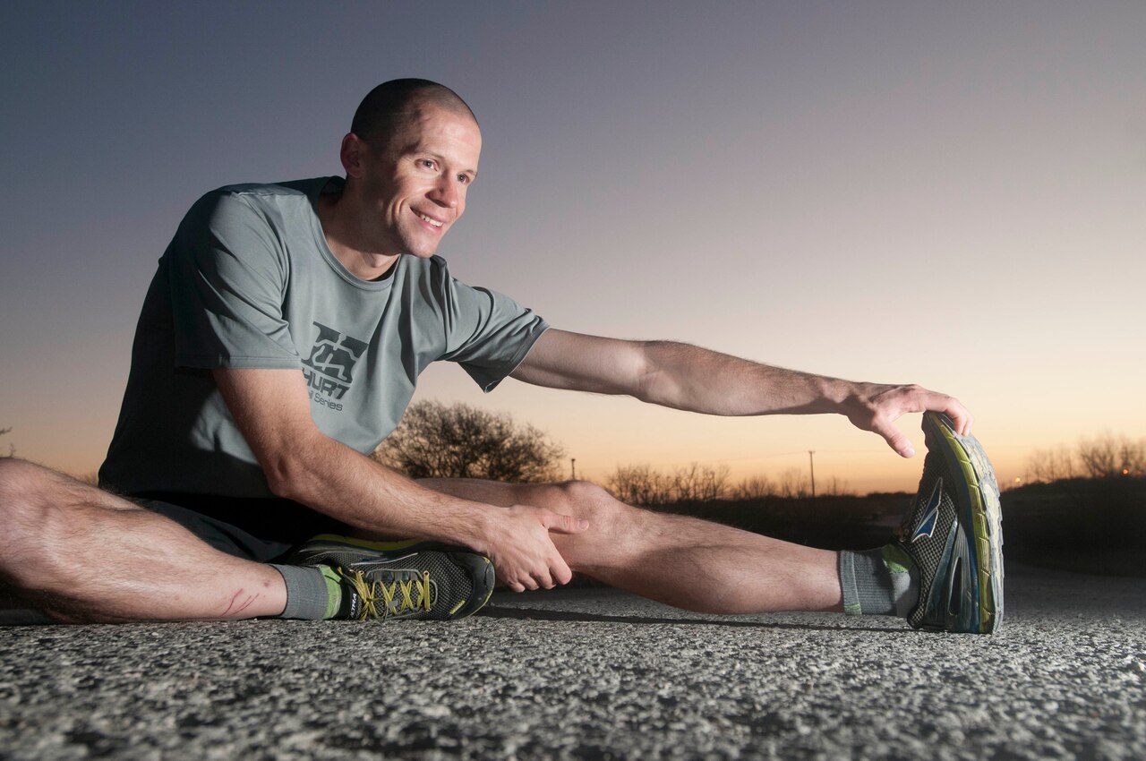 Army Sgt. Douglas Long, a Colorado Springs, Colo., native and a radio and communications security repairer for Company J, 1st Battalion, 12th Cavalry Regiment, 3rd Armored Brigade Combat Team, 1st Cavalry Division, performs some stretches at Fort Hood, Texas, Feb. 2, 2016. Long enjoys running marathons and 100-mile races. Army photo by Sgt. Brandon Banzhaf