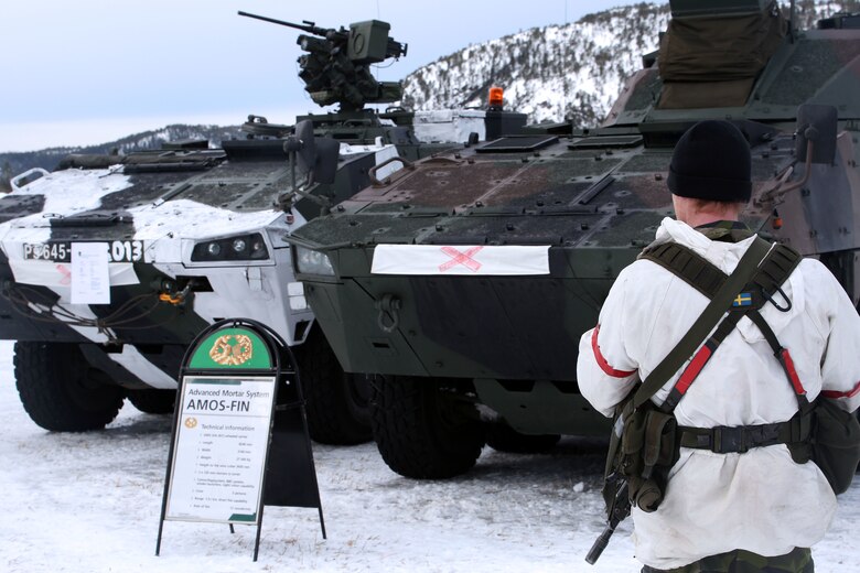 A Swedish soldier waits to present the capabilities of an armored personnel carrier on display in Namsos, Norway, March 1, 2016, during Distinguished Visitor Day as part of Exercise Cold Response 16. Distinguished Visitor Day provided high-ranking personnel from all 13 participating countries an overview of the scope, intent and capabilities achieved through integration of personnel and equipment among NATO allies and partners nations. During Cold Response, more than 15,000 troops will work together, learn from each other and sustain and strengthen partnerships, operational capabilities, and coordination.