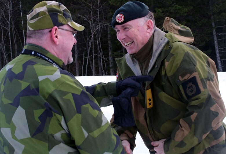 A Norwegian officer (right) and Swedish officer exchange warm welcomes in Namsos, Norway, March 1, 2016, during Distinguished Visitor Day as part of Exercise Cold Response 16. Distinguished Visitor Day provided high-ranking personnel from all 13 participating countries an overview of the scope, intent and capabilities achieved through integration of personnel and equipment among NATO allies and partners nations. During Cold Response, more than 15,000 troops will work together, learn from each other and sustain and strengthen partnerships, operational capabilities, and coordination.