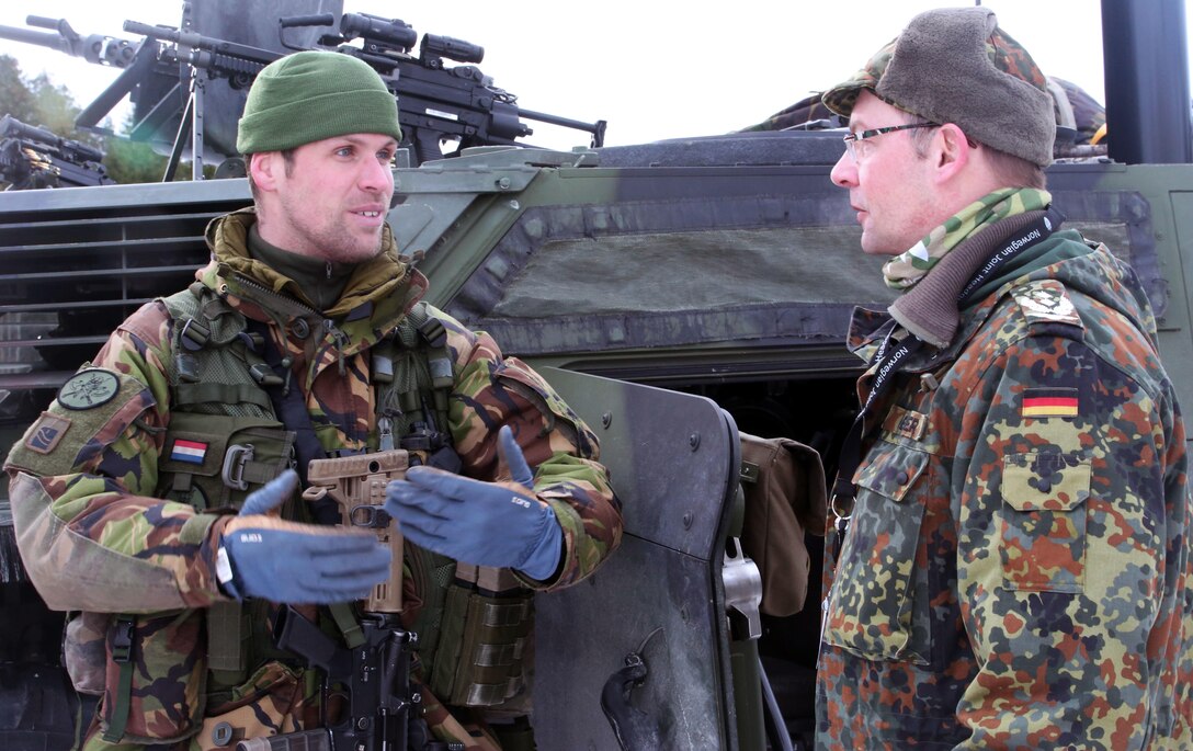 A Dutch soldier (left) talks to a German officer about the capabilities of weapons systems on display in Namsos, Norway, March 1, 2016, during Distinguished Visitor Day as part of Exercise Cold Response 16. Distinguished Visitor Day provided high-ranking personnel from all 13 participating countries an overview of the scope, intent and capabilities achieved through integration of personnel and equipment among NATO allies and partners nations. During Cold Response, more than 15,000 troops will work together, learn from each other and sustain and strengthen partnerships, operational capabilities, and coordination.