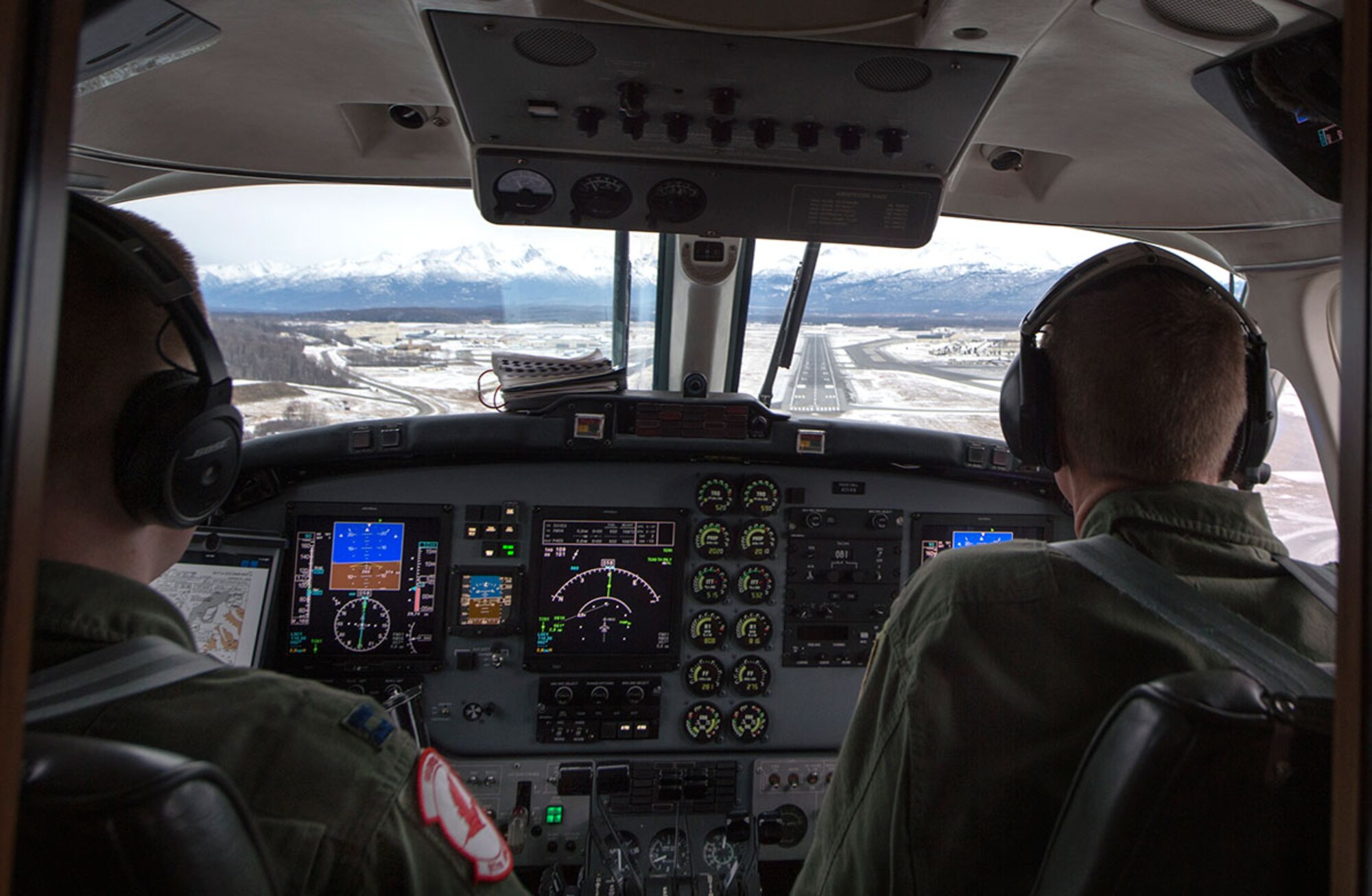 Maj. Ryan Wong, left, prepares to land at Joint Base Elmendorf-Richardson, Alaska, Feb. 23, 2016, while Lt. Col. Blake Johnson watches as part of site pilot training. Wong and Johnson are both assigned to the 517th Airlift Squadron. (U.S. Air Force photo/Staff Sgt. Sheila deVera)