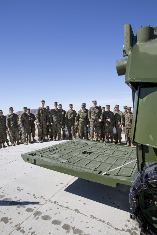 Marines from Combat Logistics Battalion-453 watch as an amphibious assault vehicle lowers its rear ramp during a test track run at Production Plant Barstow on Feb.19. The CLB Marines spent the day aboard Marine Corps Logistics Base Barstow learning about the maintenance operations carried out at the plant and received a period of military instruction on rail operations.
