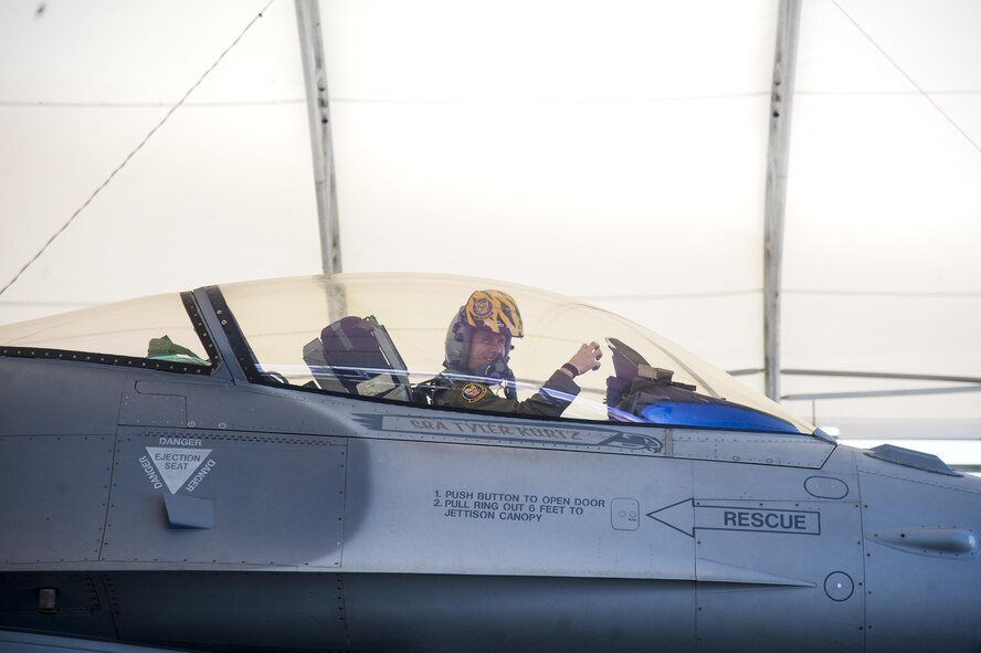 An F-16 Fighting Falcon pilot from Shaw Air Force Base, poses for a picture during a preflight inspection, Feb. 18, 2016, at Moody Air Force Base, Ga. Multiple U.S. Air Force aircraft within Air Combat Command conducted joint aerial training at Grand Bay Bombing and Gunnery Range. During the training, the aircraft conducted tactical air and ground maneuvers, as well as weapons training. (U.S. Air Force photo by Andrea Jenkins/Released)