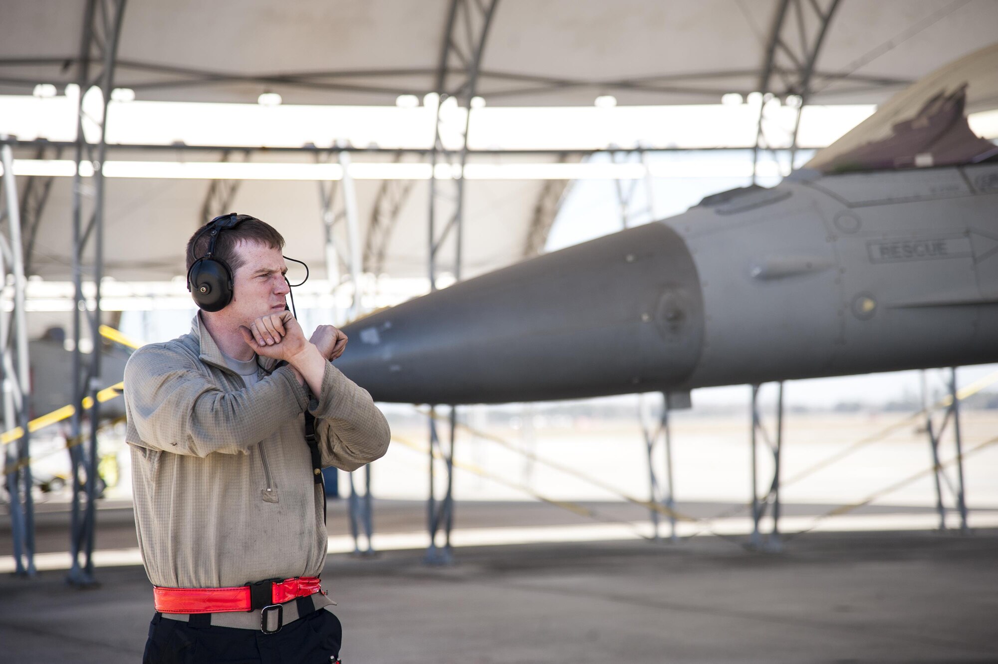 A crew chief marshals a U.S. Air Force F-16 Fighting Falcon from Shaw Air Force Base, prior to takeoff, Feb. 18, 2016, at Moody Air Force Base, Ga. Multiple U.S. Air Force aircraft within Air Combat Command conducted joint aerial training at Grand Bay Bombing and Gunnery Range. During the training, the aircraft conducted tactical air and ground maneuvers, as well as weapons training. (U.S. Air Force photo by Andrea Jenkins/Released)