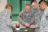Students of the 94th Training Division's Petroleum Supply Specialist Reclassification Course at Fort Lee, Va., work as a team organizing and inventorying a test kit before moving from the classroom to the field to begin fuel testing as they learn the fundamentals of being a fueler.