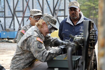 Russell Datts, civilian contractor and instructor at the 94th Training Division's Petroleum Supply Specialist Reclassification Course, tests Spc. Kirsten Gray and another student on fuel testing techniques in the field at Fort Lee, Va.