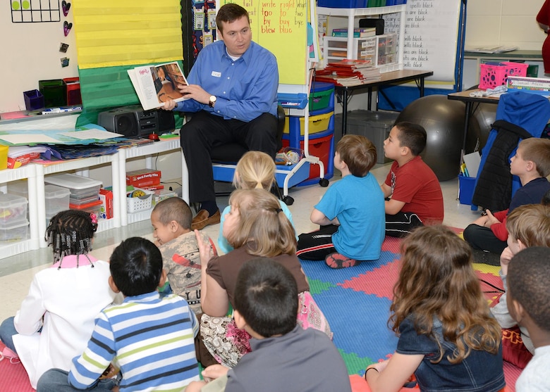 Jerad McIntyre, Engineering and Support Center, Huntsville Special Projects Program project manager, reads Marge Palatini's "Piggie Pie" March 1, to Horizon Elementary School first graders during the National Education Association's Read Across America event.