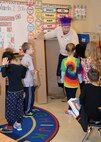 Chief of Operations Russ Dunford, U.S. Army Engineering and Support Center Huntsville helps Mill Creek Elementary School kindergarten students build a puppet theater and tent out of cardboard boxes after he read them a book during National Education Association's Read Across America Day, March 2.