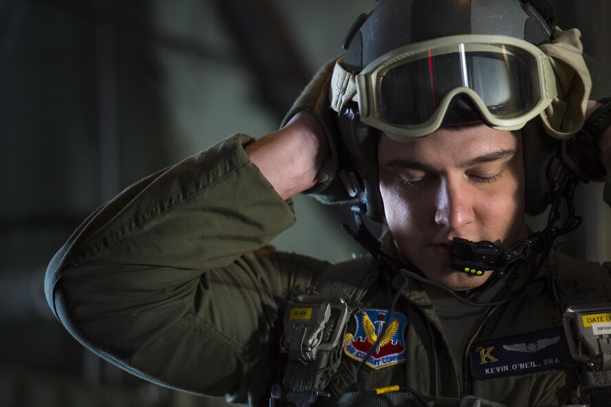 U.S. Air Force Senior Airman Kevin O’Neil, 71st Rescue Squadron loadmaster, adjusts his helmet prior to conducting personnel drops from an HC-130J Combat King II, Feb. 18, 2016, in the skies over South Ga.  Multiple U.S. Air Force aircraft within Air Combat Command conducted joint aerial training at Grand Bay Bombing and Gunnery Range. During the training, the aircraft conducted tactical air and ground maneuvers, as well as weapons training. (U.S. Air Force photo by Senior Airman Ryan Callaghan/Released)