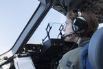 Capt. Megan Flynt, a pilot with the 249th Airlift Squadron, scans the skies here Feb. 24, 2016, as she returns to Oahu from a mission in Kauai. Almost 50 Alaska Air Guard members of the 249th Airlift Squadron, 212th Rescue Squadron and 176th Wing support units participated in a search and rescue exercise in the Pacific Air Forces' warmer waters of Honolulu. 