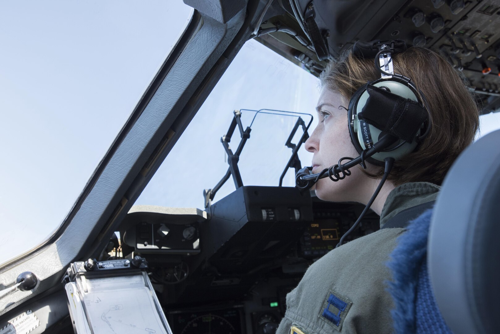 Capt. Megan Flynt, a pilot with the 249th Airlift Squadron, scans the skies here Feb. 24, 2016, as she returns to Oahu from a mission in Kauai. Almost 50 Alaska Air Guard members of the 249th Airlift Squadron, 212th Rescue Squadron and 176th Wing support units participated in a search and rescue exercise in the Pacific Air Forces' warmer waters of Honolulu. 
