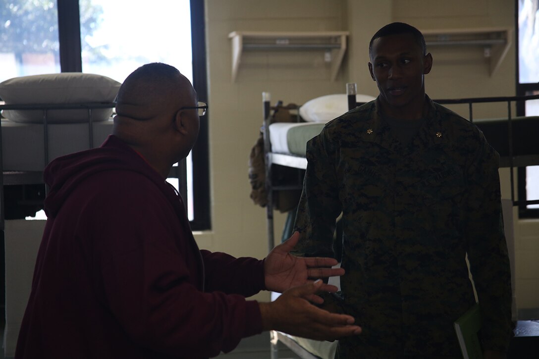 Maj. Kendrick Gaines, commanding officer of Recruiting Station Atlanta, speaks with Martin Orr, an educator from Buford High School, in the Bravo Company barracks aboard Marine Corps Recruit Depot Parris Island, S.C., Mar. 2, 2016. The three-day workshop will give educators a chance to experience the day to day routines aboard the depot and Marine Corps Air Station Beaufort. The purpose of the workshop is to give educators a better understanding of the Marine Corps and reinforce the idea of the Marine Corps as a viable career option. (U.S. Marine Corps photo by Cpl. John-Paul Imbody)
