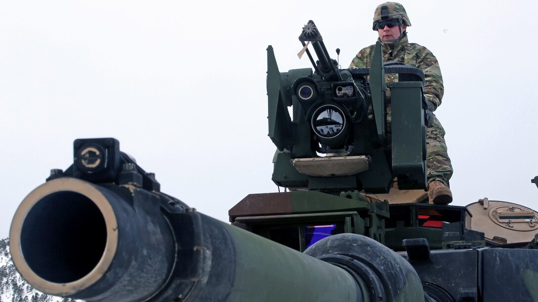 A U.S. Army soldier presents the capabilities of an M1A2 tank on display in Namsos, Norway, March 1, 2016, during Distinguished Visitor Day as part of Exercise Cold Response 16. Distinguished Visitor Day provided high-ranking personnel from all 13 participating countries an overview of the scope, intent and capabilities achieved through integration of personnel and equipment among NATO allies and partners nations. During Cold Response, more than 15,000 troops will work together, learn from each other and sustain and strengthen partnerships, operational capabilities, and coordination.