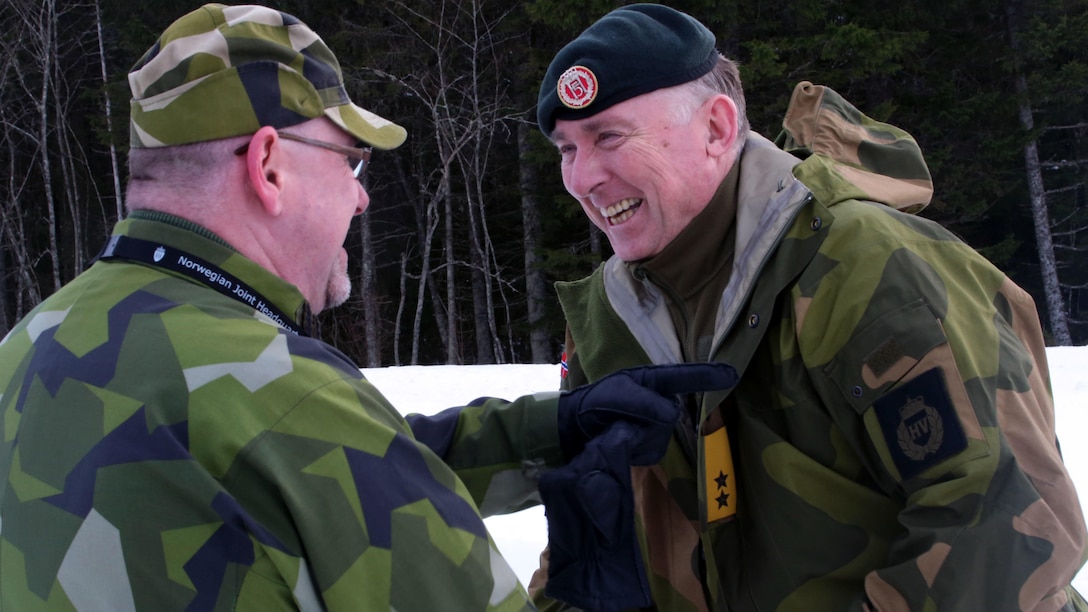 A Norwegian officer (right) and Swedish officer exchange warm welcomes in Namsos, Norway, March 1, 2016, during Distinguished Visitor Day as part of Exercise Cold Response 16. Distinguished Visitor Day provided high-ranking personnel from all 13 participating countries an overview of the scope, intent and capabilities achieved through integration of personnel and equipment among NATO allies and partners nations. During Cold Response, more than 15,000 troops will work together, learn from each other and sustain and strengthen partnerships, operational capabilities, and coordination.