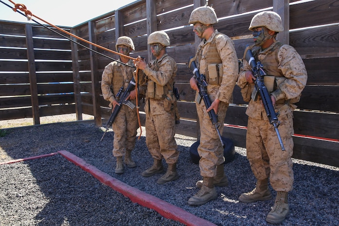 Private First Class Armando Sajbin, Echo Company, 2nd Recruit Training Battalion, makes plans with his fire team about how to complete an obstacle during the Crucible at Marine Corps Base Camp Pendleton, Calif., Feb. 24. One rule that was consistent across all challenges was to avoid the areas painted red, which simulated a casualty and forced the teams to strategize at some points. Annually, more than 17,000 males recruited from the Western Recruiting Region are trained at MCRD San Diego.
