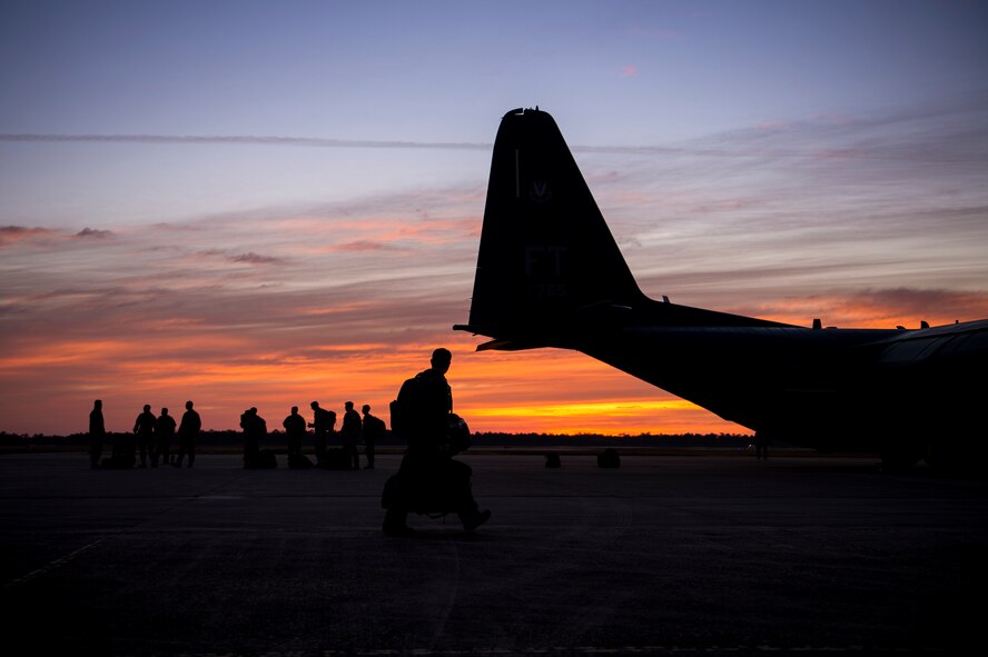 Aircrew from the 71st Rescue Squadron and jumpers from the 93d Air Ground Operations Wing prepare to board an HC-130J Combat King II, Feb. 17, 2016, at Moody Air Force Base, Ga.  Multiple U.S. Air Force aircraft within Air Combat Command conducted joint aerial training at Grand Bay Bombing and Gunnery Range. During the training, the aircraft conducted tactical air and ground maneuvers, as well as weapons training. (U.S. Air Force photo by Senior Airman Ryan Callaghan/Released)