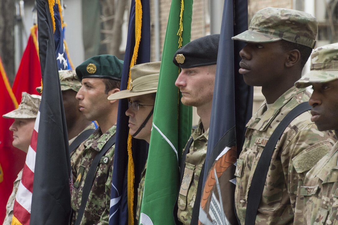 A color guard with U.S. and NATO service members participate in a change-of-command ceremony in Kabul, Afghanistan, March 2, 2016. Marine Corps Gen. Joseph F. Dunford Jr., right, chairman of the Joint Chiefs of Staff, and Army Gen. Lloyd J. Austin III, left, commander of U.S. Central Command, attended the ceremony during which Army Gen. John F. Campbell relinguished command to Army Gen. John W. Nicholson Jr. DoD photo by D. Myles Cullen