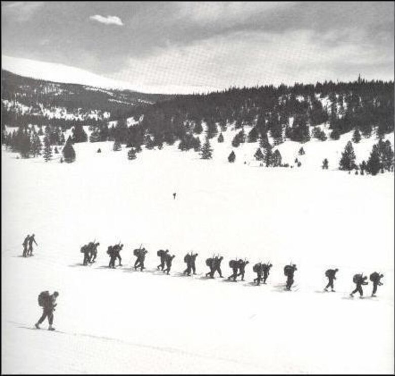 Men of the 99th Infantry Battalion hike during a 17-mile trail day in March, 1943. The training was aimed at preparing the men for operations in a cold weather environment. Maj. William Colby led a group of men from the battalion during Operation Rype in sabotage missions aimed at preventing German troops from moving in Norway during World War II.