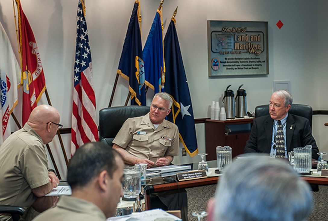 Vice Adm. Thomas Rowden, Commander, Naval Vice Adm. Thomas Rowden, Commander, Naval Surface Forces U.S. Pacific Fleet (middle) and Jim McClaugherty, deputy commander, DLA Land and Maritime (right) listen to Navy Rear Adm. John King, commander, DLA Land and Maritime (left) during a briefing for Rowden March 2 at Defense Supply Center Columbus. Rowden visited Columbus to hear about the capabilities of DLA and ways Land and Maritime can align with Rowden's forces in support of the warfighter. 