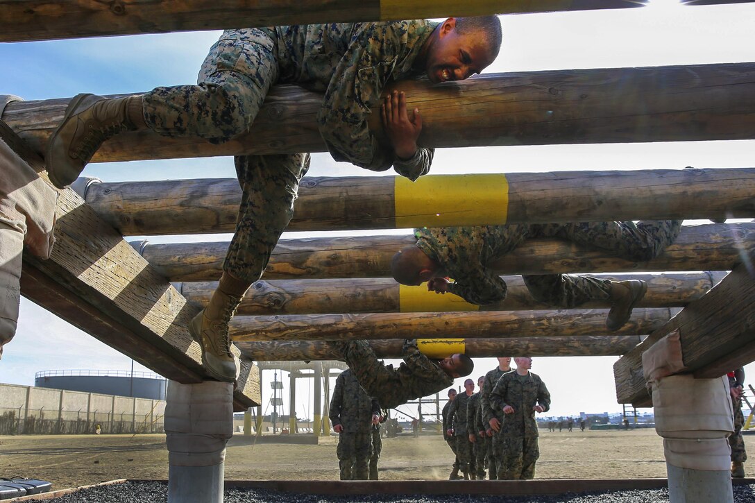 Marine recruits navigate a log obstacle while maintaining a low profile during training on Marine Corps Recruit Depot San Diego, Feb. 23, 2016. The recruits, assigned to Alpha Company, 1st Recruit Training Battalion, are scheduled to graduate April 22, 2016. Marine Corps photo by Lance Cpl. Angelica Annastas