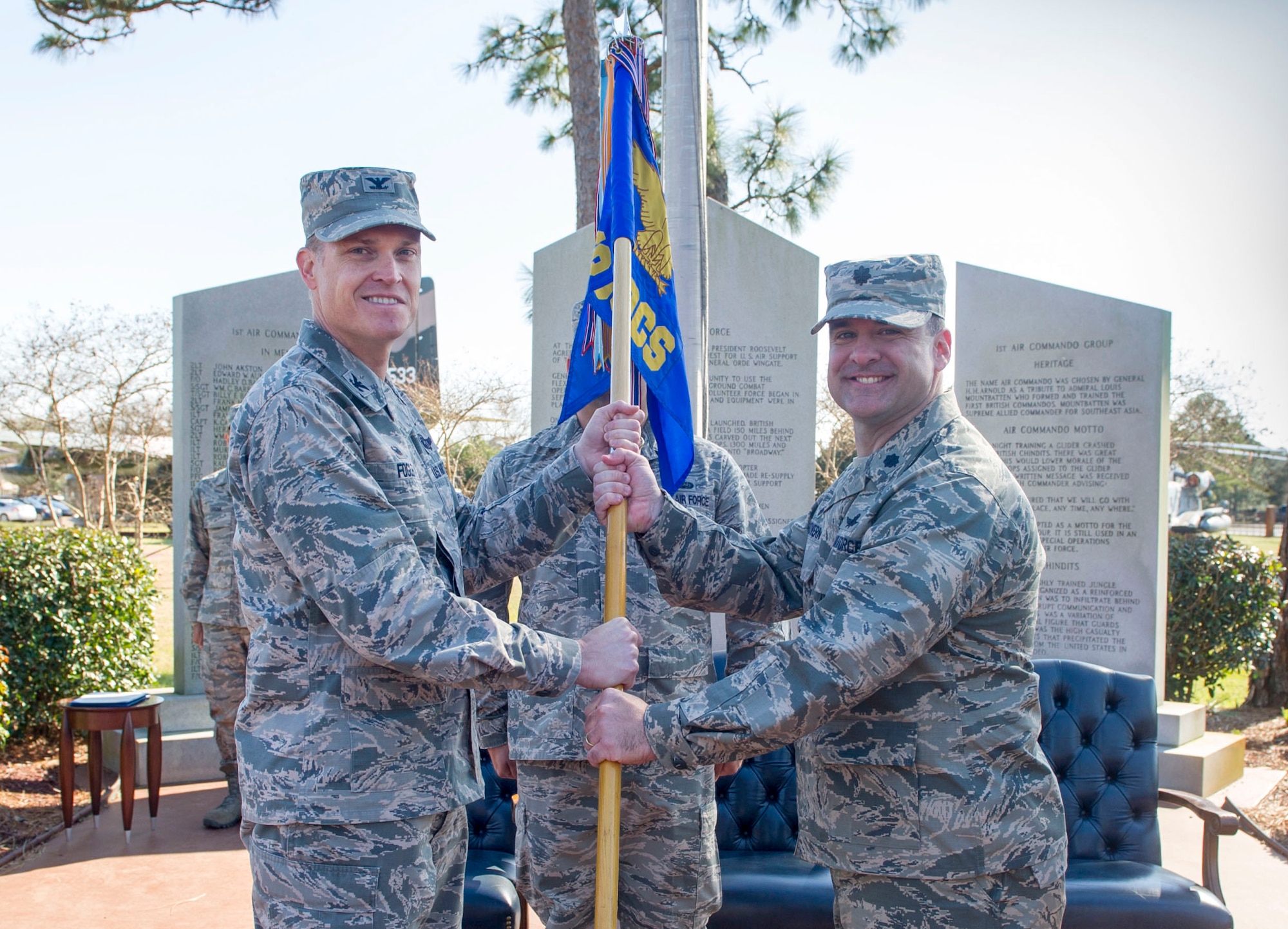 Col. Todd Fogle, commander of the 1st Special Operations Mission Support Group, passes the guidon to Lt. Col. Scott McGovern, the new commander of the 1st Special Operations Communications Squadron, during a change of command ceremony at Hurlburt Field, Fla., Feb. 26, 2016. The passing of the unit guidon is a time-honored military tradition representing the changing of command from one leader to another. (U.S. Air Force photo by Senior Airman Krystal M. Garrett)