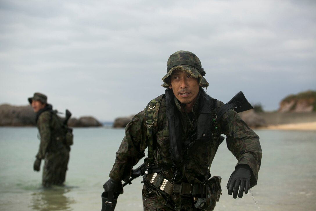 A service member with the Japan Ground Self-Defense Force finishes practicing scout swimming techniques March 1, at Kin Blue, Okinawa, Japan. The JGSDF members observed Marines from 3rd Reconnaissance Battalion, 3rd Marine Division, III Marine Expeditionary Force,  practice scout swimmer techniques and conduct raid missions. The JGSDF members are with 43rd Infantry Regiment. (U.S. Marine photo by Cpl. Robert Williams Jr./Released)