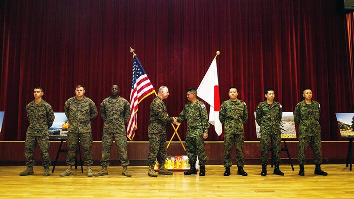 U.S. Marine Corps Col. Clay Tipton, commanding officer, 11th Marine Expeditionary Unit, shakes hands with Col. Yoskiyuki Goto, commanding officer, Western Army Infantry Regiment, Japan Ground Self-Defense Force, after recognizing select Marines and JGSDF soldiers for their outstanding  performance during Exercise Iron Fist 2016, at the exercise’s closing ceremony at Camp Pendleton, March 1, 2016. Exercise Iron Fist is an annual exercise conducted between the USMC and JGSDF, designed to improve their ability to conduct amphibious operations. The ceremony brought together both militaries in celebration and formally concluded the 11th iteration of Exercise Iron Fist. 