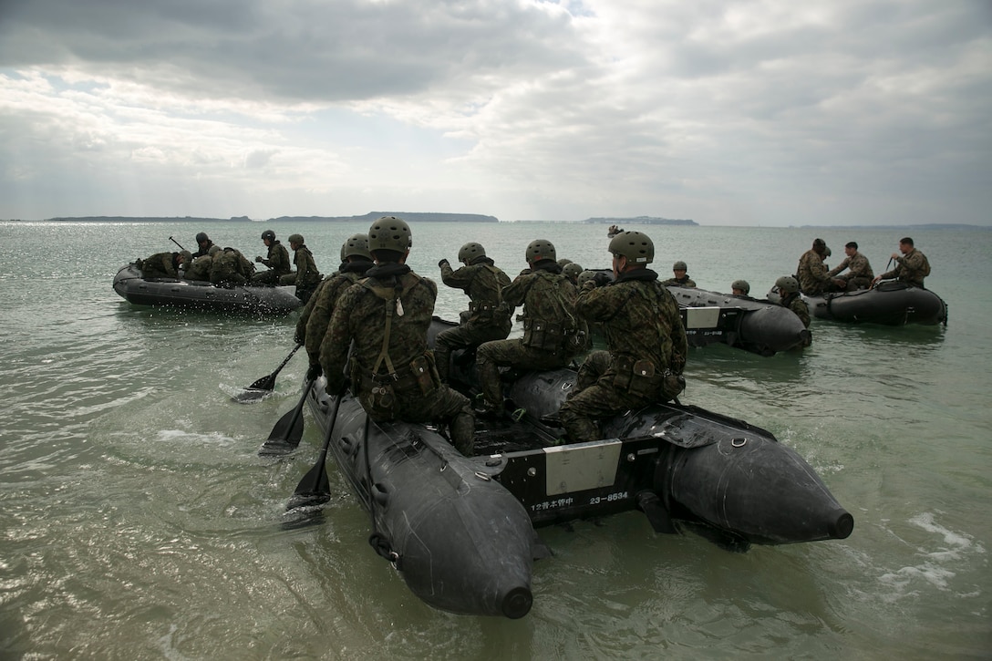 Service members with the Japan Ground Self-Defense Force paddle out to sea in Combat Rubber Raiding Craft at Kin Blue, Okinawa, Japan, March 1. The JGSDF members observed Marines from 3rd Reconnaissance Battalion, 3rd Marine Division, III Marine Expeditionary Force, practice scout swimmer techniques and conduct raid missions. The JGSDF members are with 43rd Infantry Regiment. (U.S. Marine photo by Cpl. Robert Williams Jr./Released)