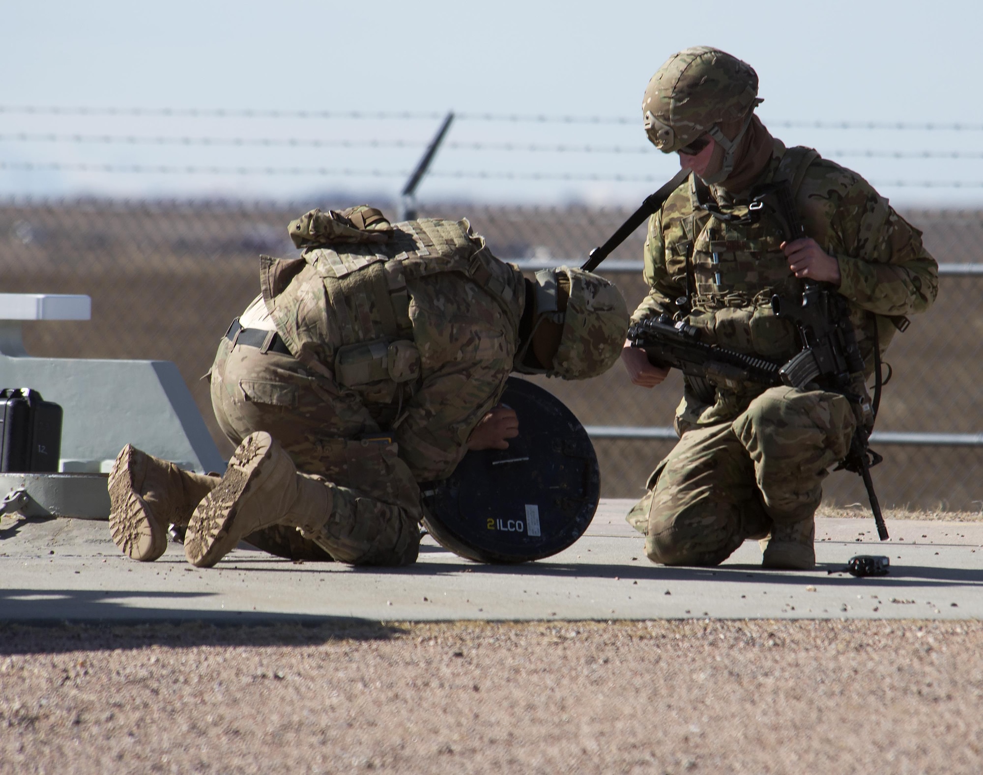 Defenders with the 790th Missile Security Forces Squadron go through the steps required to open the access hatch at Launch Facility Alpha-10 in Laramie County, Wyo., Feb. 19, 2016. The hatch was being opened so maintainers with the 90th Missile Maintenance Squadron of F.E. Warren AFB could get in to work on the Minuteman III inside. (U.S. Air Force photo by R.J. Oriez)