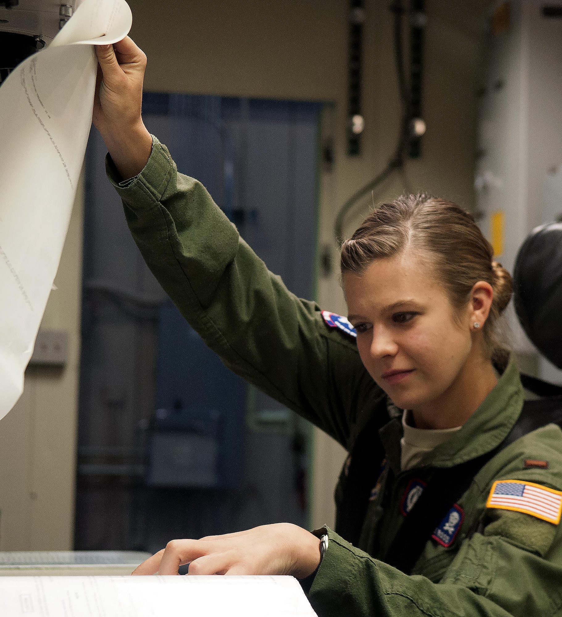 Second Lt. Madeline Ross, 319th Missile Squadron deputy combat crew commander, reads through a set of technical orders during a training exercise inside a missile procedure trainer on F.E. Warren Air Force Base, Wyo., August 13, 2015. Missileers monitor launch facilities and remain in constant communication with maintainers while working out at sites. (U.S. Air Force file photo by Airman 1st Class Brandon Valle)