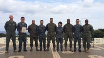 Members of the Japanese Air Self Defense Force pose with U.S. Marines for a photo at a farewell luncheon for the professional military exchange program February 23 at the Habu Pit Officers’ Club on Marine Corps Air Station Futenma. The professional military exchange program benefits JASDF and Marines by providing first-hand insight to the daily routines and responsibilities of each service, according to Staff Sgt. Shinya Nishida, second from left. The experience and knowledge gained through the program establishes better understanding and communication. After Nishida’s exposure to the Marine Corps, the JASDF will return the favor by taking in a Marine in March to experience day-to-day routines of the JASDF. Nishida was a participant of the program and is a flight plan dispatcher with the JASDF.