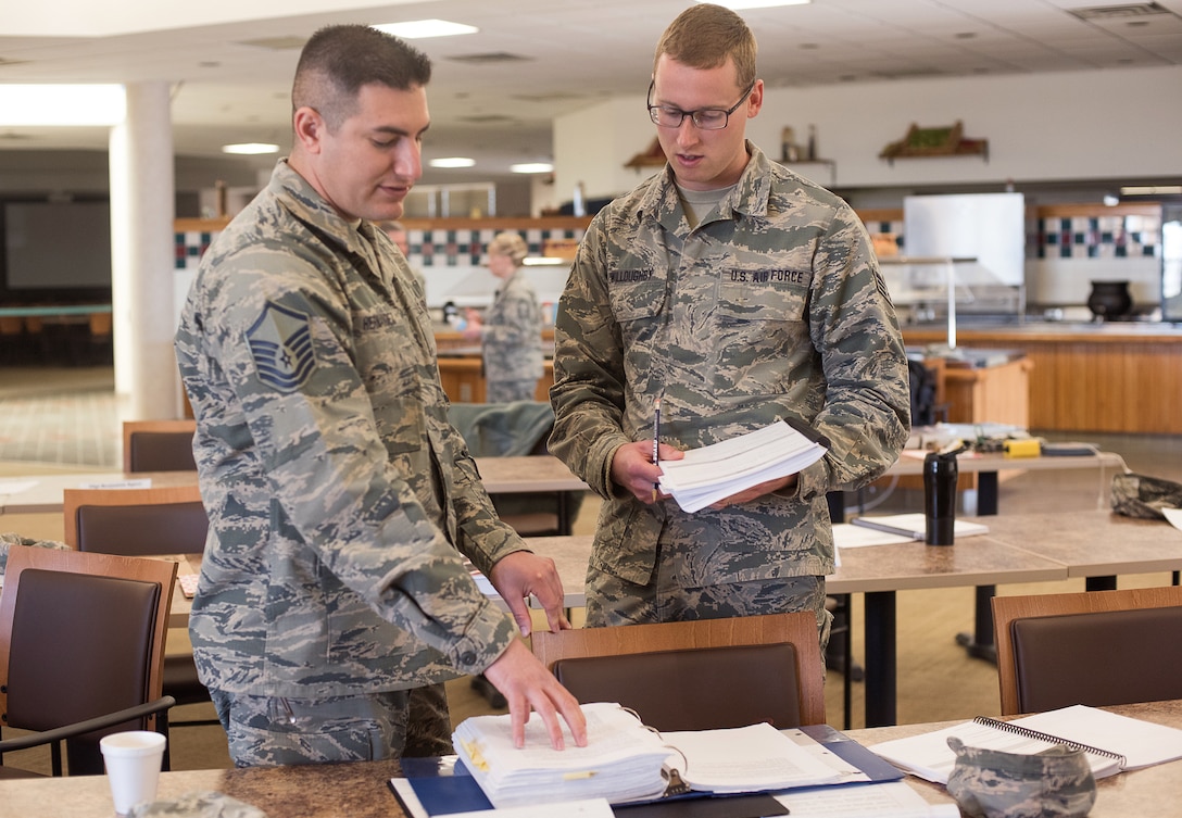 Master Sgt. John Hernandez, the 137th Air Refueling Wing safety and occupation health manager, and Senior Airman Jonathan Willoughby from the 137th Operations Support Flight, 137th Air Refueling Wing, Oklahoma City, discuss safety requirements and regulations after compiling data from a mock inspection at Will Rogers Air National Guard Base, Oklahoma City, Feb. 25, 2016. The inspection was part of an Air National Guard-wide, four-day safety orientation course, which was mainly for unit safety representatives and supervisors, that focused on the importance of safety and mishap prevention. (U.S. Air National Guard photo by Senior Airman Kasey Phipps)