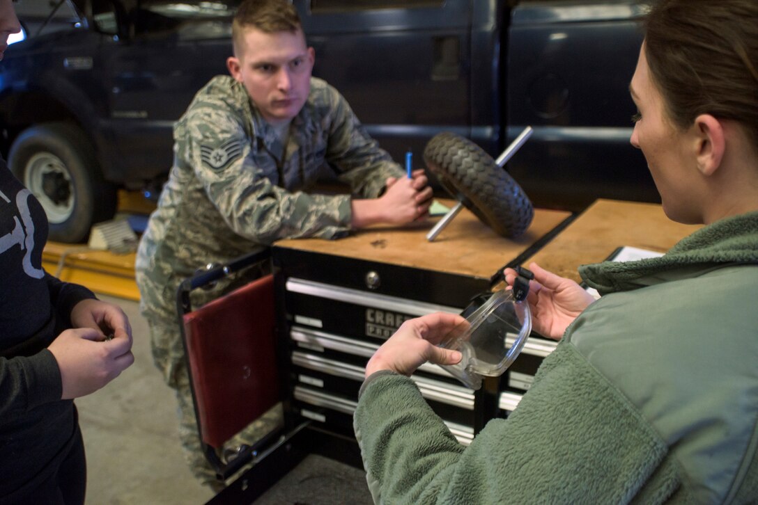 Staff Sgt. Dylan Robins from the 137th Vehicle Maintenance Squadron, 137th Air Refueling Wing, Oklahoma City, listens to Tech. Sgt. Crystal Collingwood from the 190th Medical Group, Topeka, Kansas, as she explains the requirements of personal protection equipment, including the protective eyewear in her hand, during a mock inspection in the 137th Vehicle Operations Squadron at Will Rogers Air National Guard Base, Oklahoma City, Feb. 25, 2016. The inspection was part of an Air National Guard-wide, four-day safety orientation course, which was mainly for unit safety representatives and supervisors, that focused on the importance of safety and mishap prevention. (U.S. Air National Guard photo by Senior Airman Kasey Phipps)